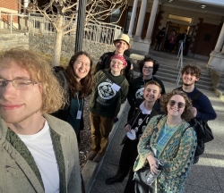 Students stand in front of building